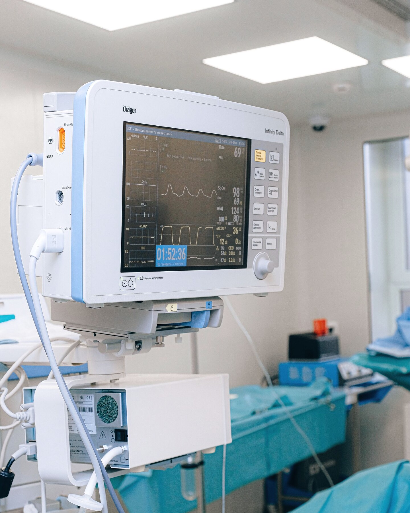 A bedside multi-parameter patient monitor showing live traces at a made-up bed.